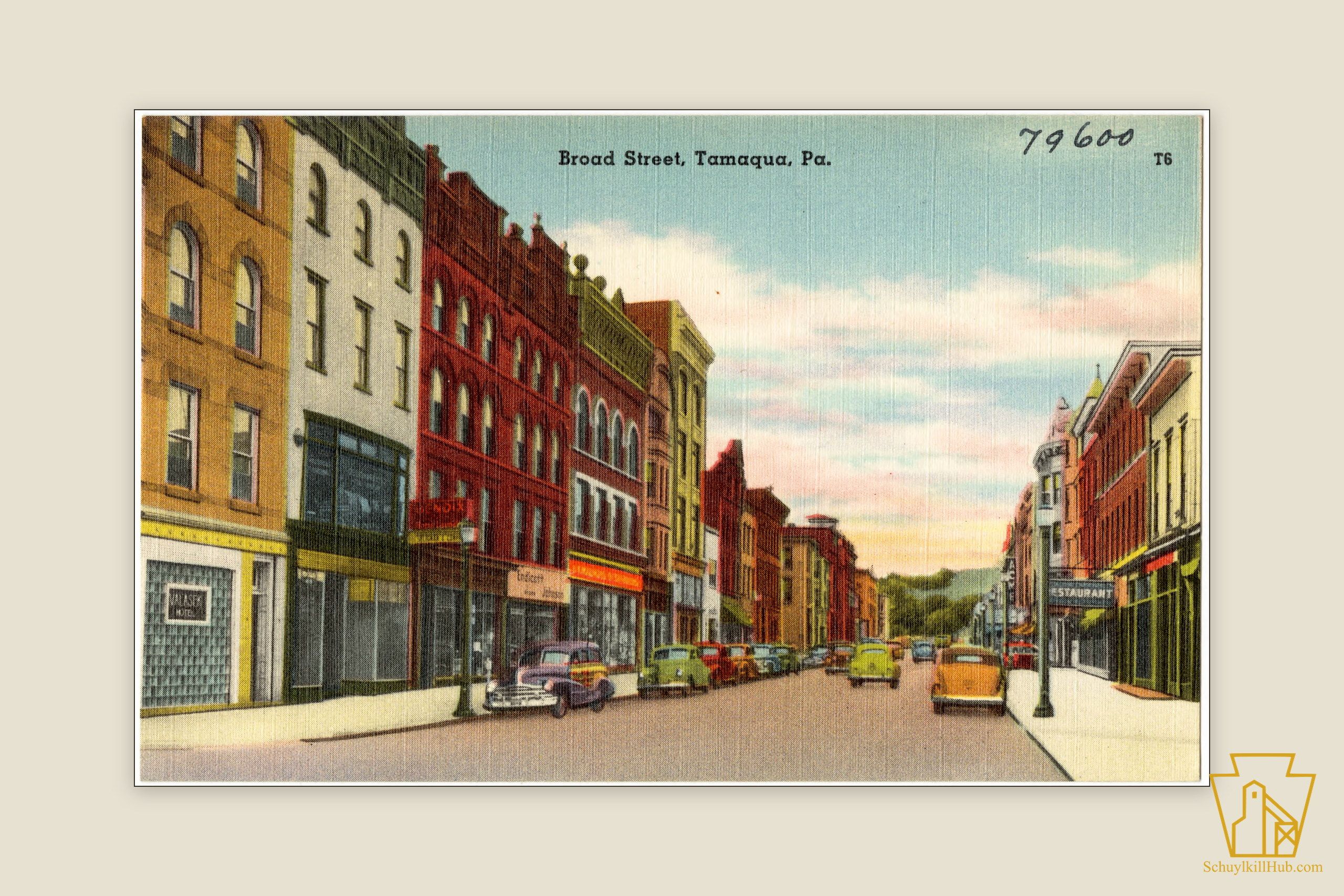 Color linen postcard of Broad Street, Tamaqua, lined with three- and four-story commercial blocks and parked cars.