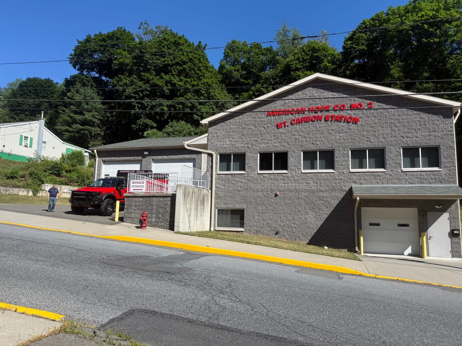 The American Hose Company No. 2 station at Mount Carbon — a gray block building lettered 'American Hose Co. No. 2, Mt. Carbon Station.'