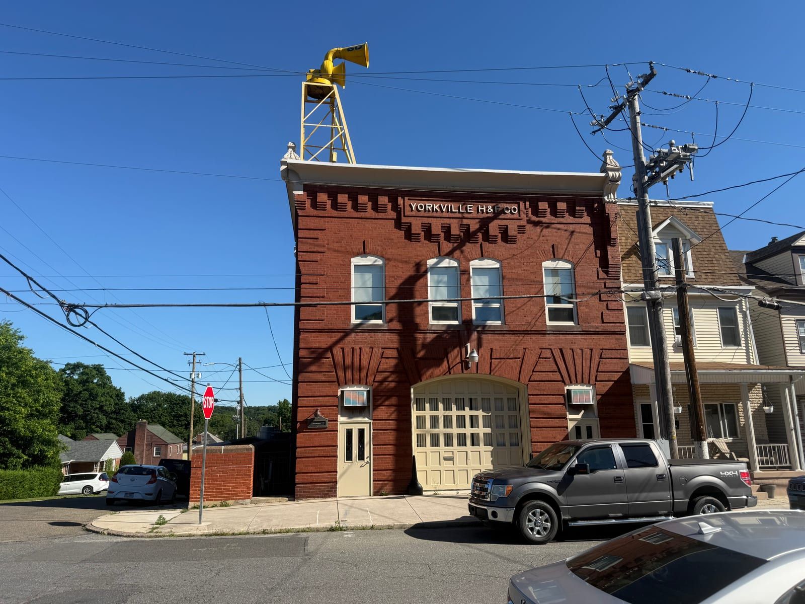The Yorkville Hose Company firehouse in Pottsville — a brick station lettered 'Yorkville H&L Co.' with a rooftop siren tower.