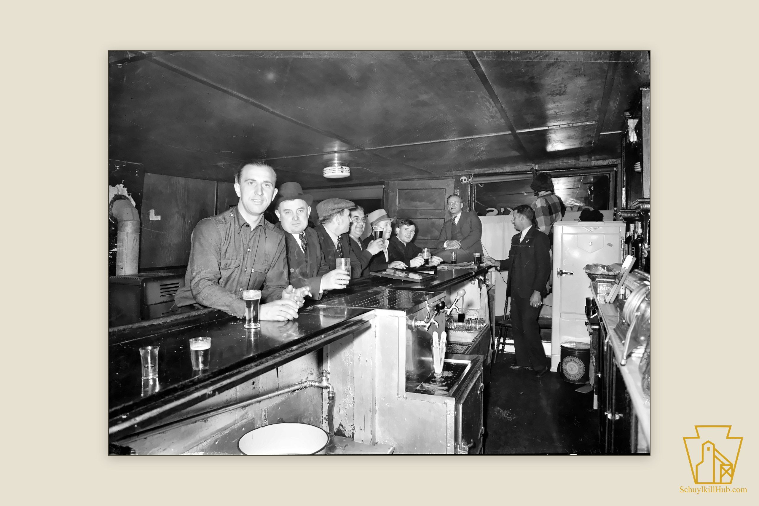 A line of men with beer glasses along a bar in Gilberton.