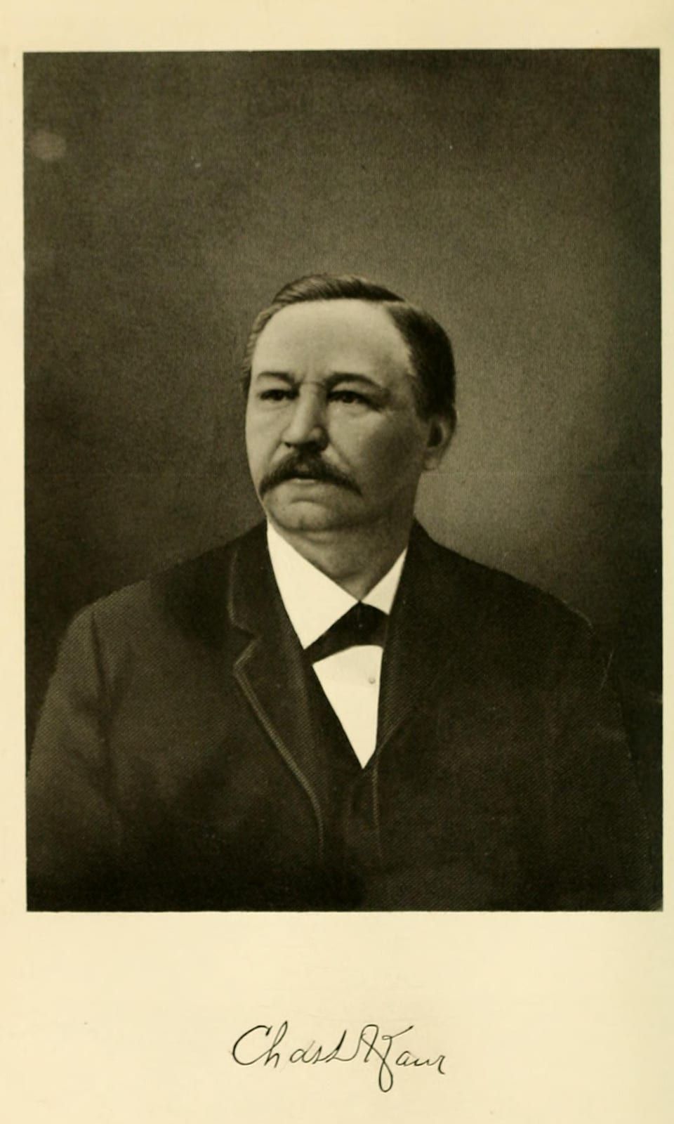 A 1907 halftone portrait of Charles D. Kaier, a heavyset man with a broad mustache, receding dark hair, a dark coat, white shirt, and black bow tie, above his facsimile signature 'Chas D Kaier.'