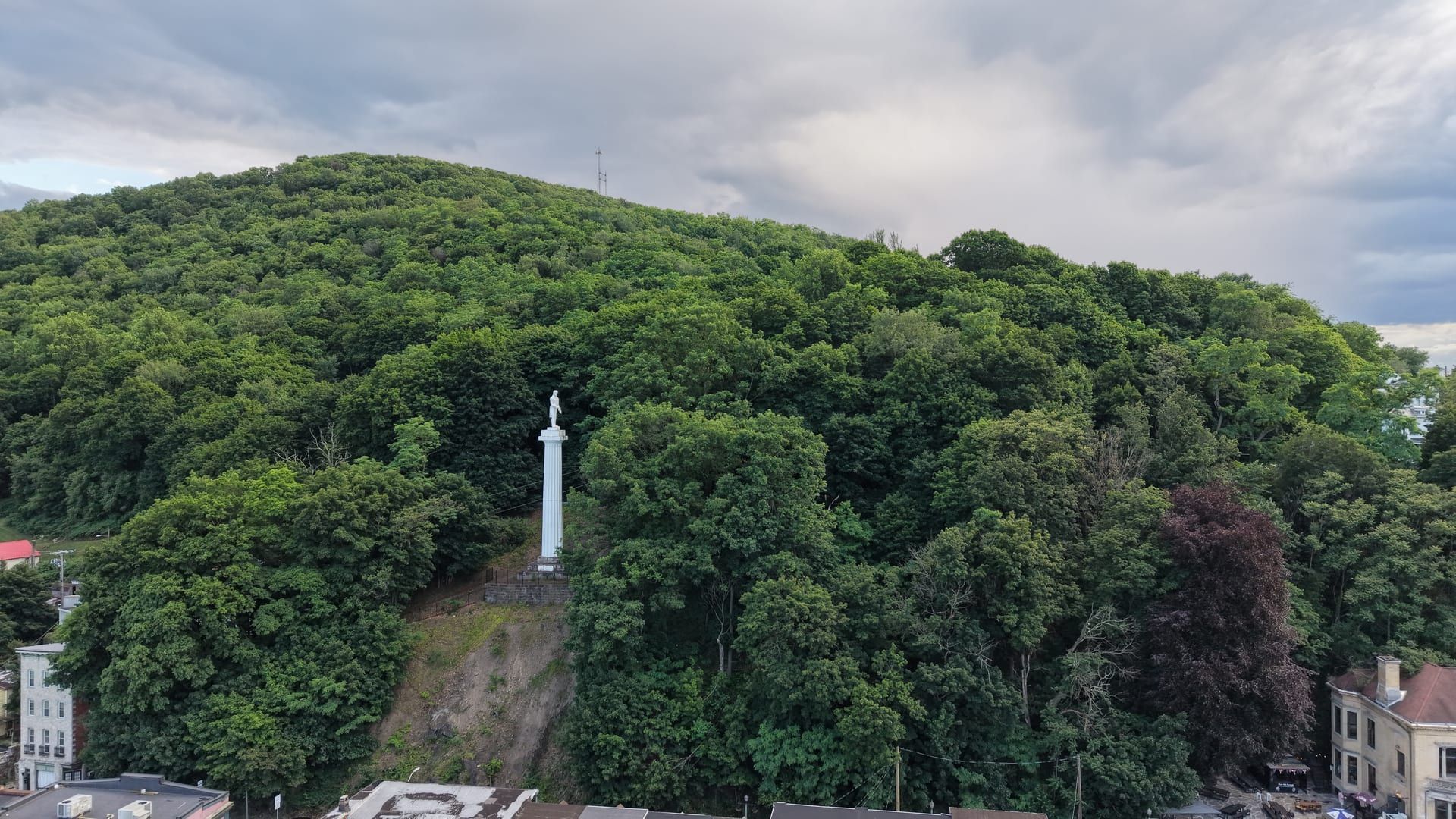 The Henry Clay Monument — a tall white column topped by a statue of Henry Clay — on the wooded hillside above downtown Pottsville.