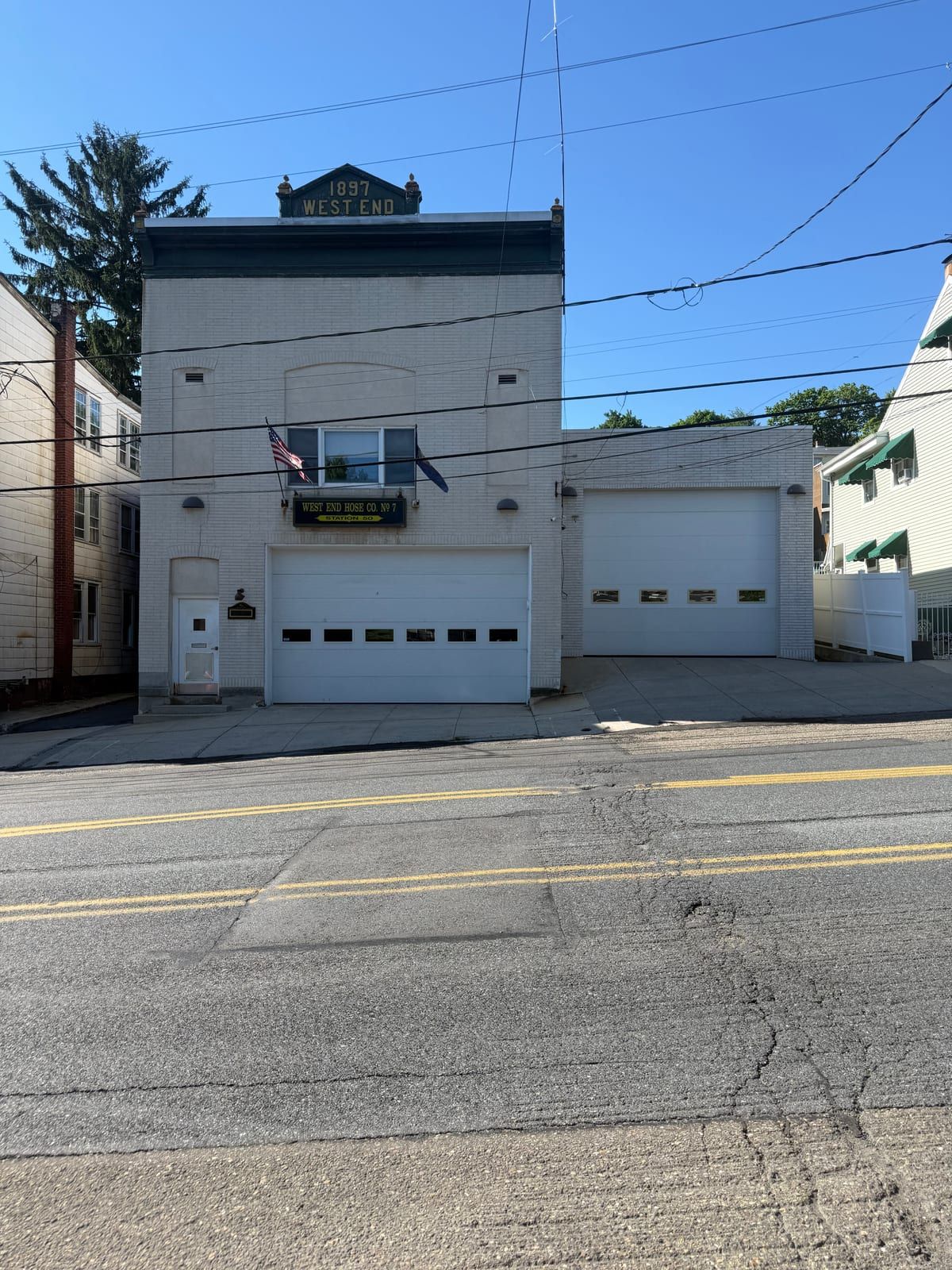 The West End Hose Company No. 7 firehouse in Pottsville — a white station with a tower lettered '1897 West End.'