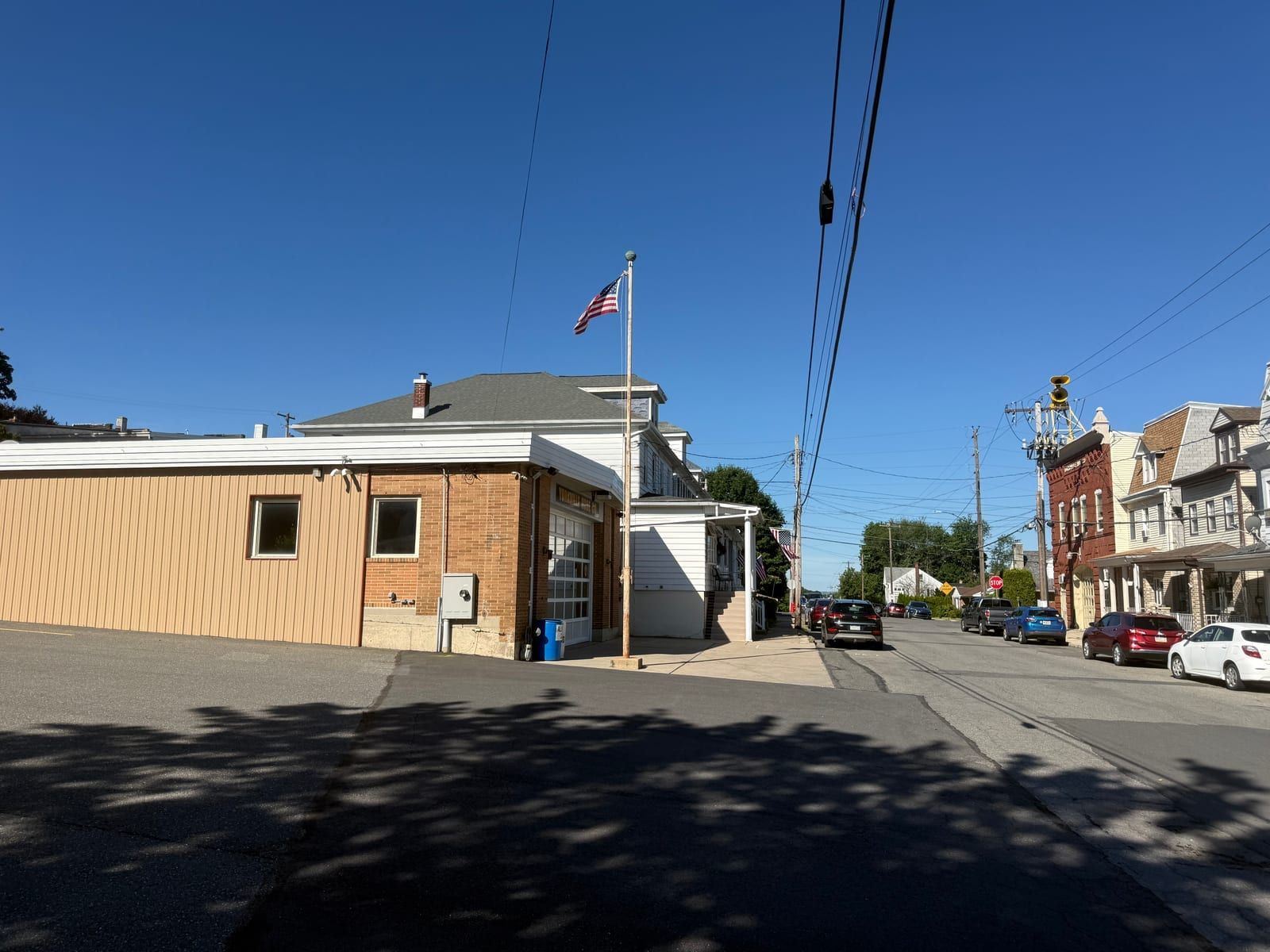 A street view along West Norwegian Street in the Yorkville section of Pottsville, with the Yorkville Hose Company's brick firehouse and siren tower down the block.