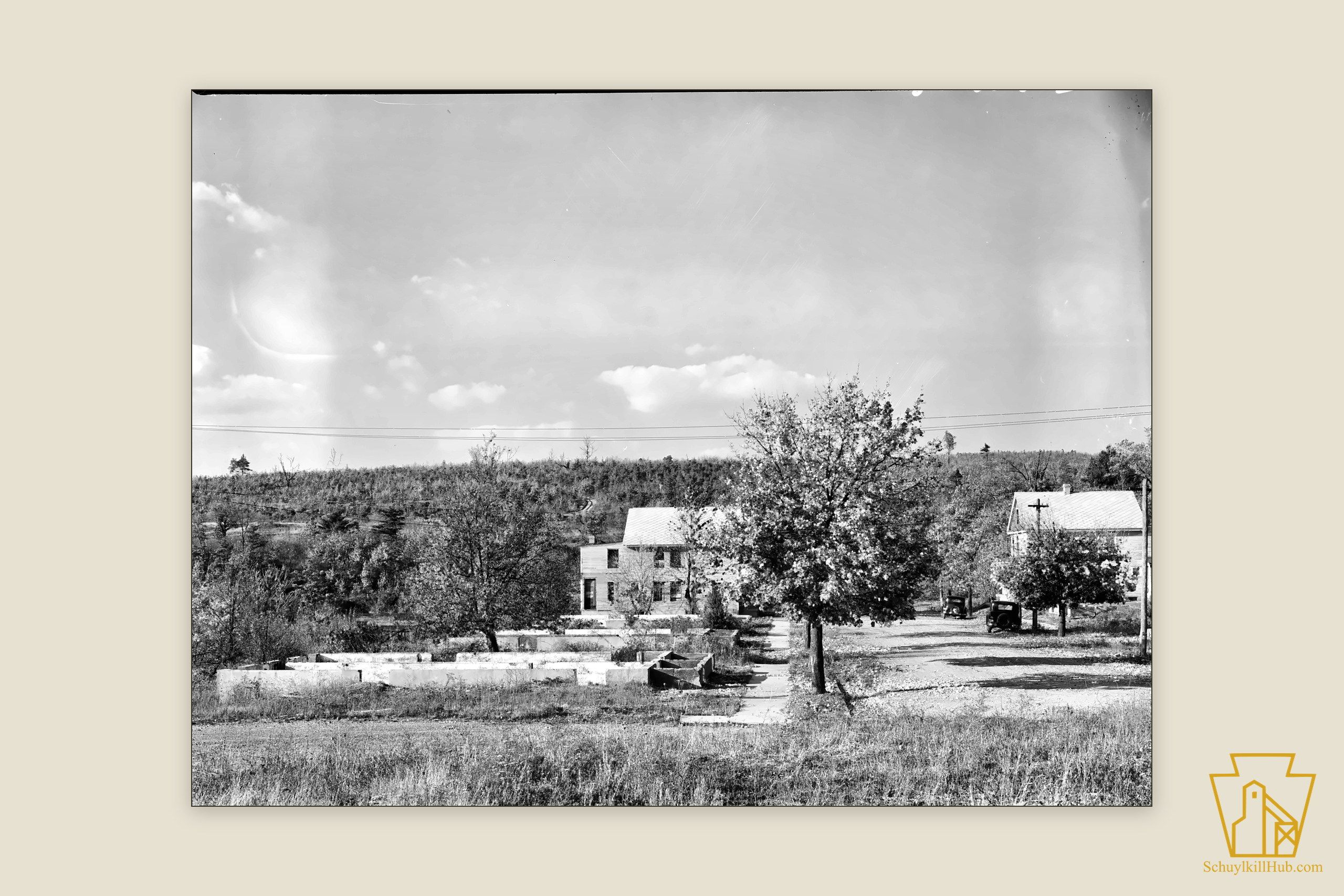A grassy hillside with scattered house foundations — the nearly erased mining patch of Lorain.