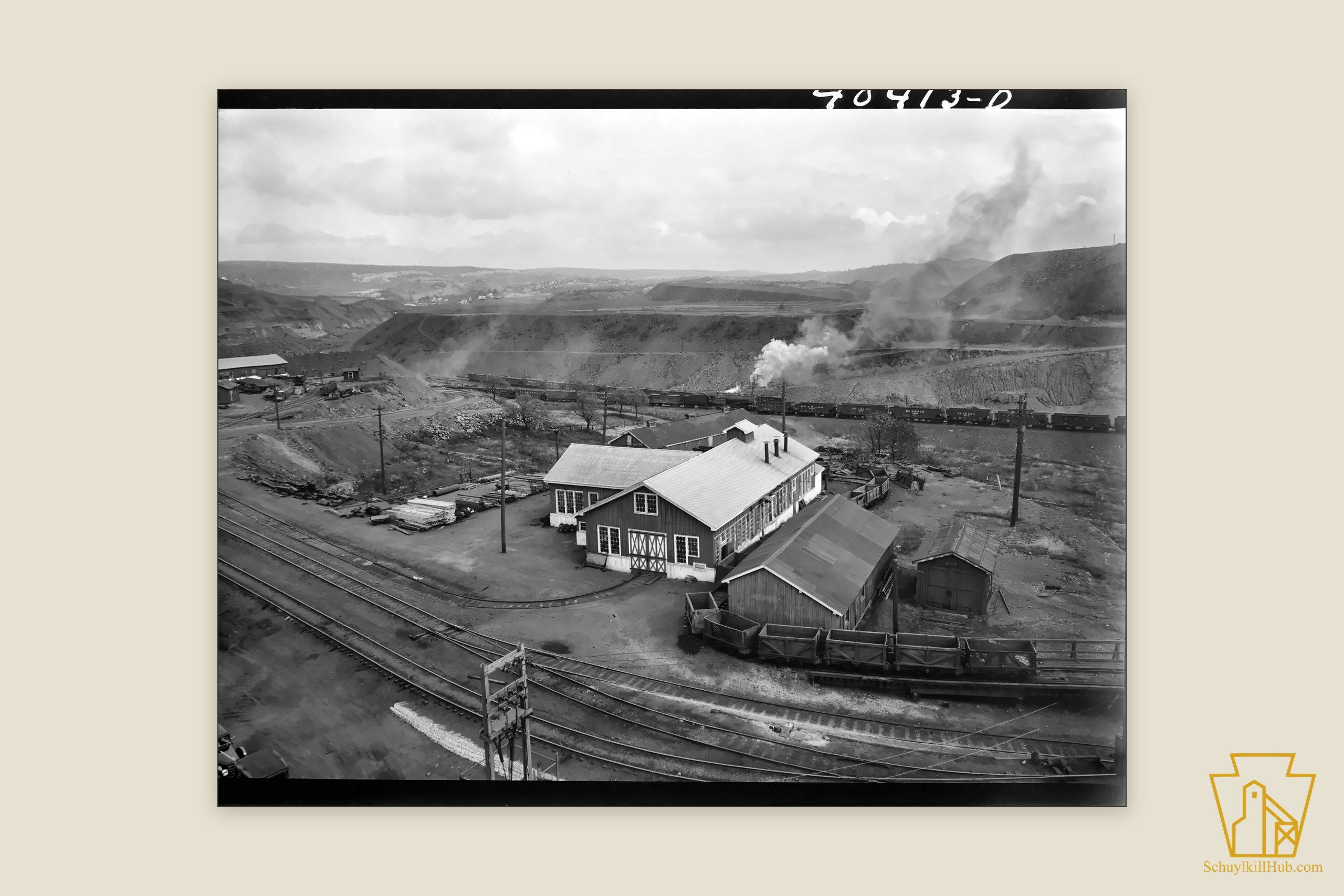 The Maple Hill colliery surface from the shaft tower — engine houses, timber stacks, coal cars and converging tracks.