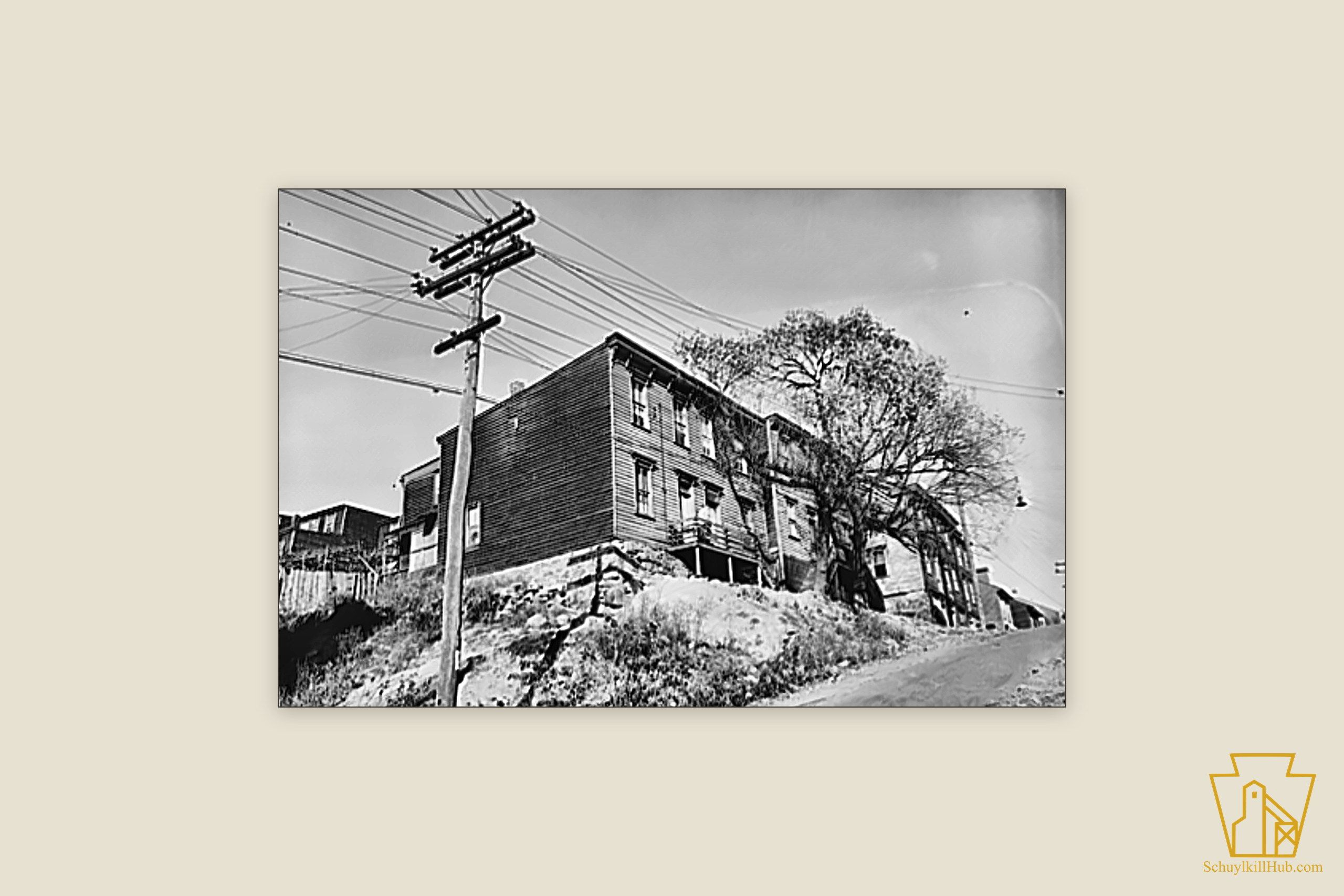 Tall clapboard company houses perched on a rocky hillside in Shenandoah.