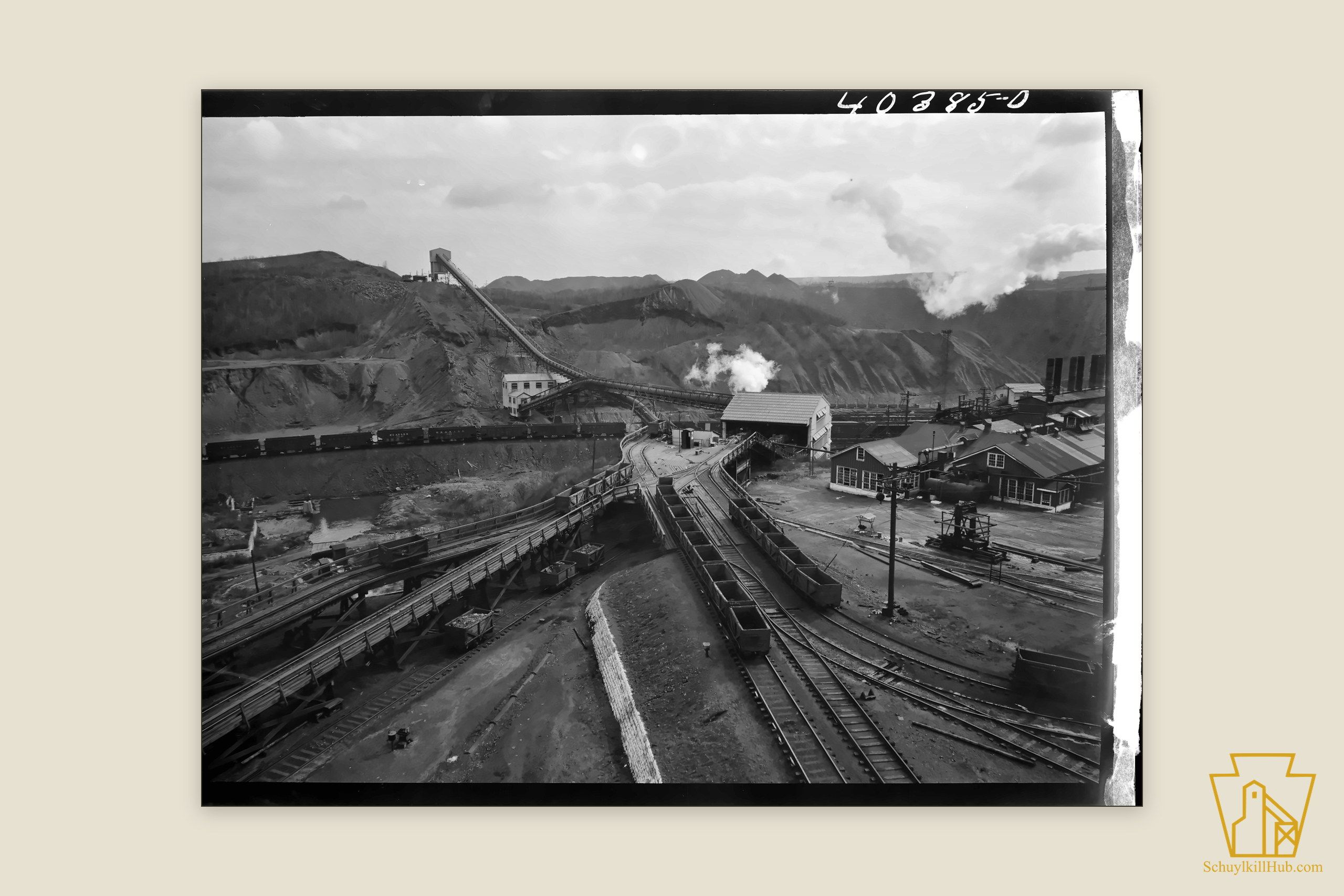 Mine tracks leading toward the towering St. Nicholas breaker, seen from a shaft tower.