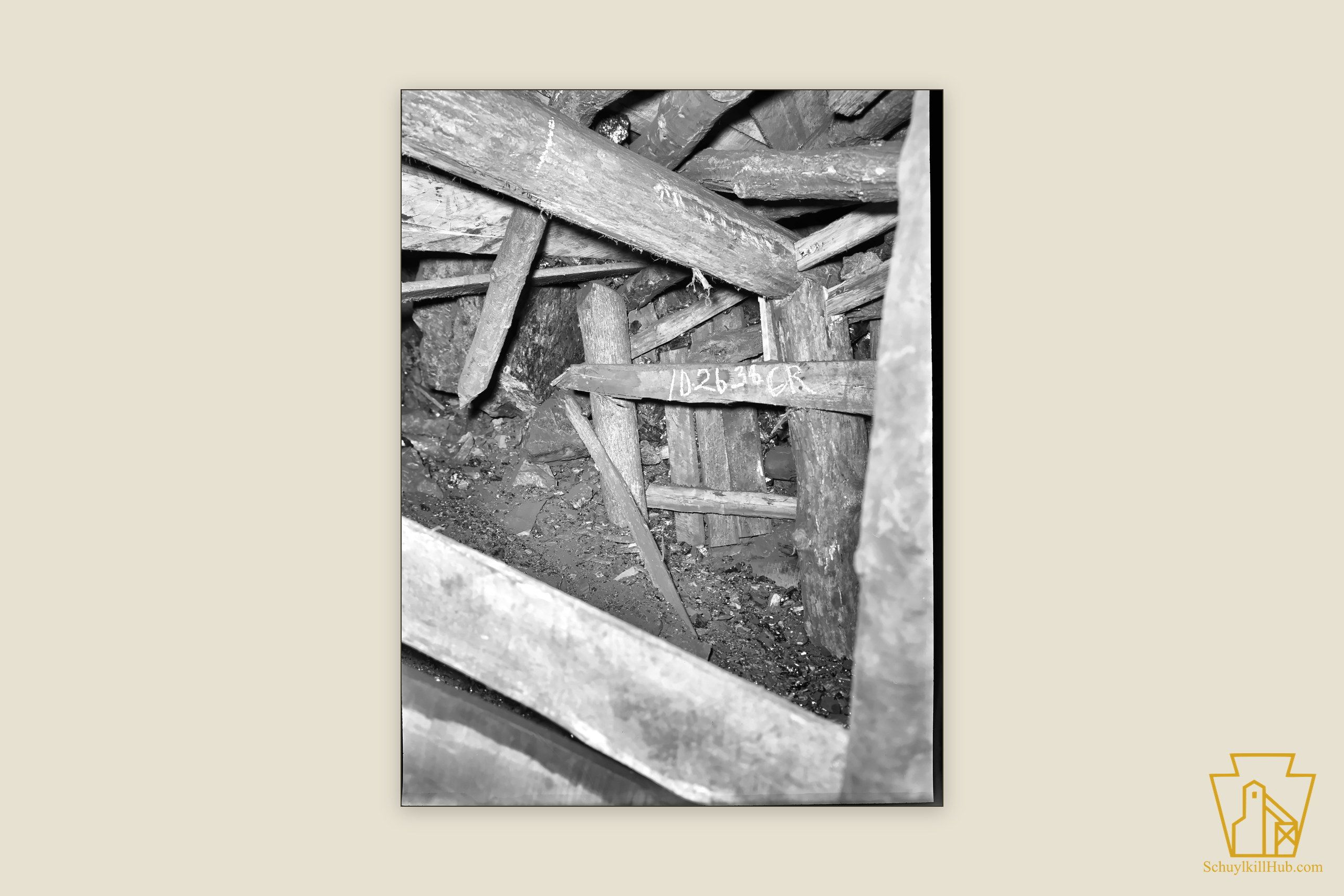 Heavy timber props and cross-beams bracing a settling mine-tunnel roof.