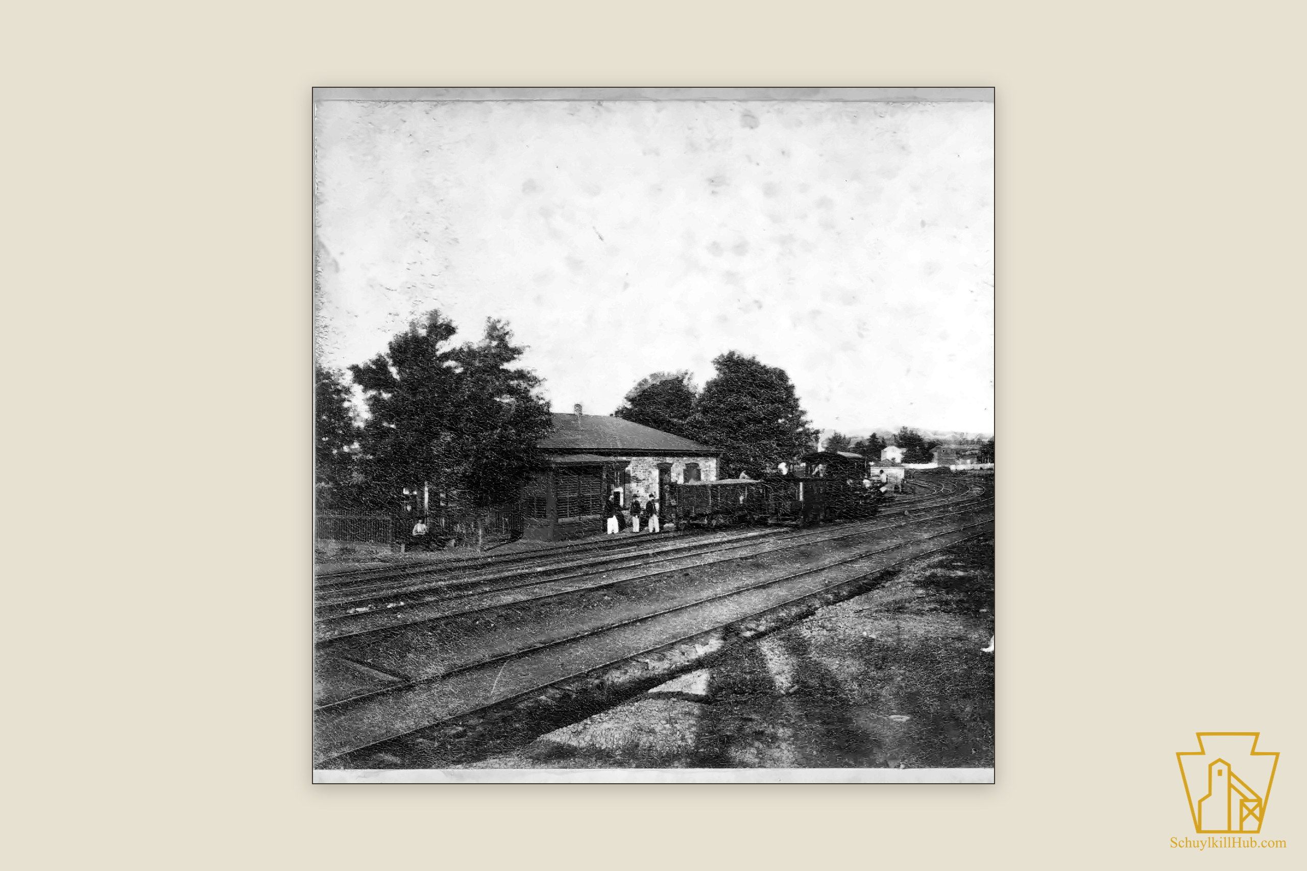 The small weighmaster’s office beside the tracks at Cressona, a locomotive and railroad men nearby.